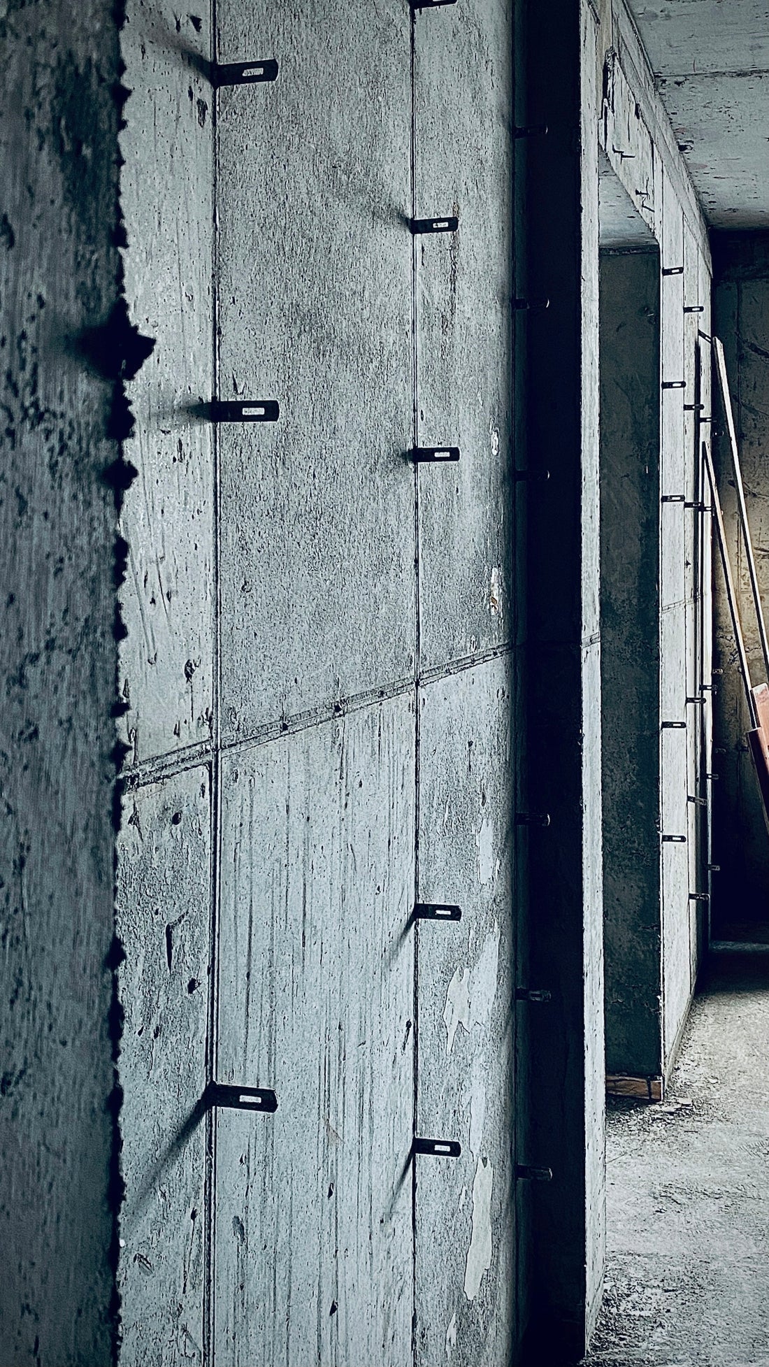 gray concrete wall with black metal fence