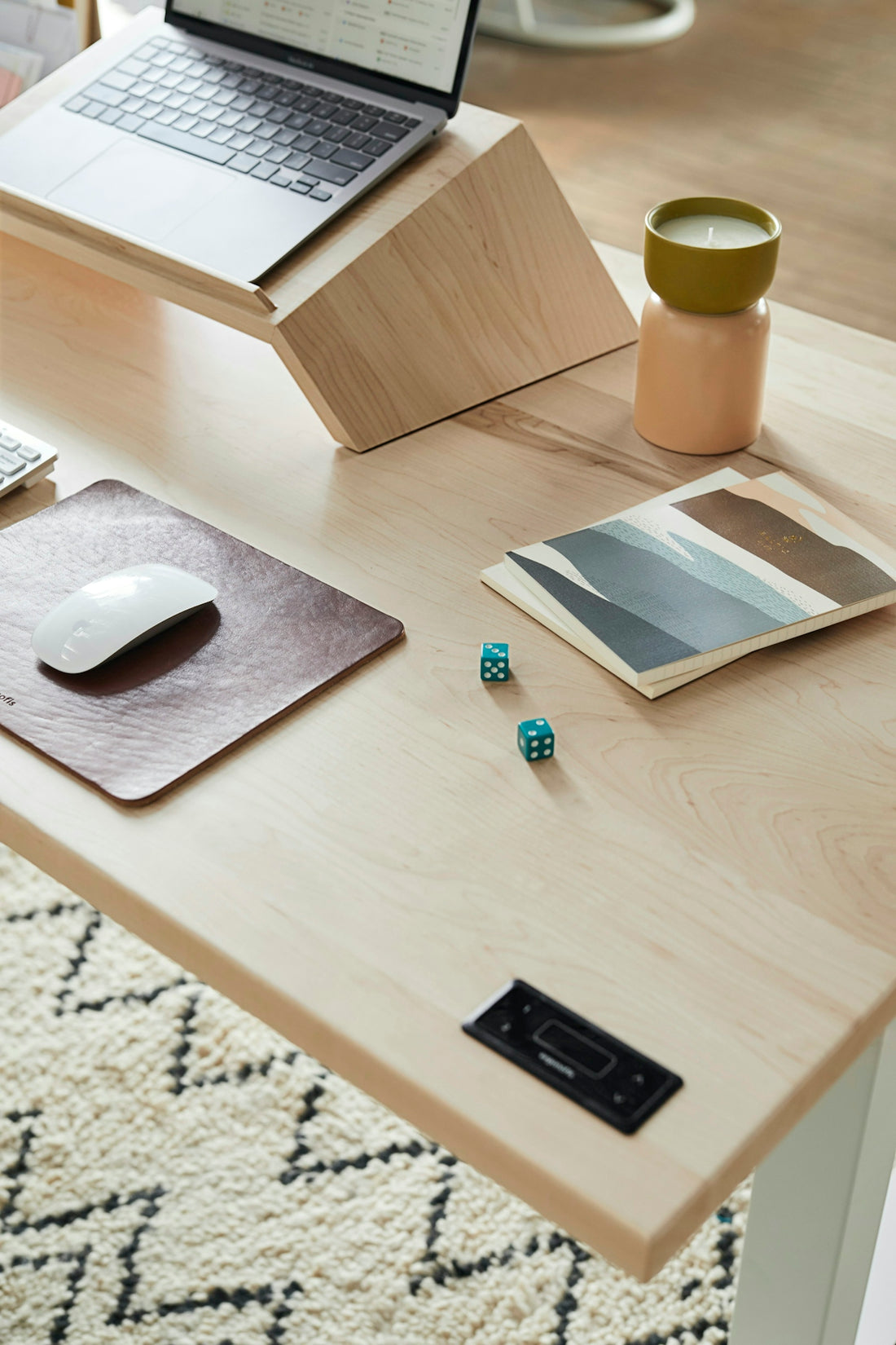 a desk with a laptop and a mouse on it