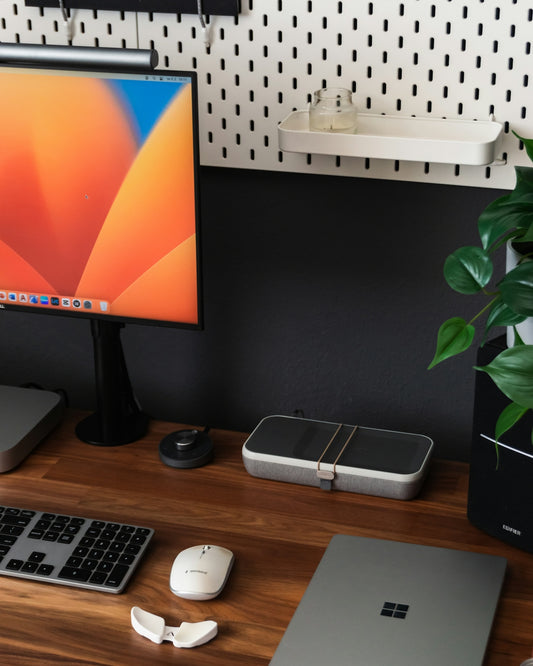 a desk with a monitor, keyboard and mouse