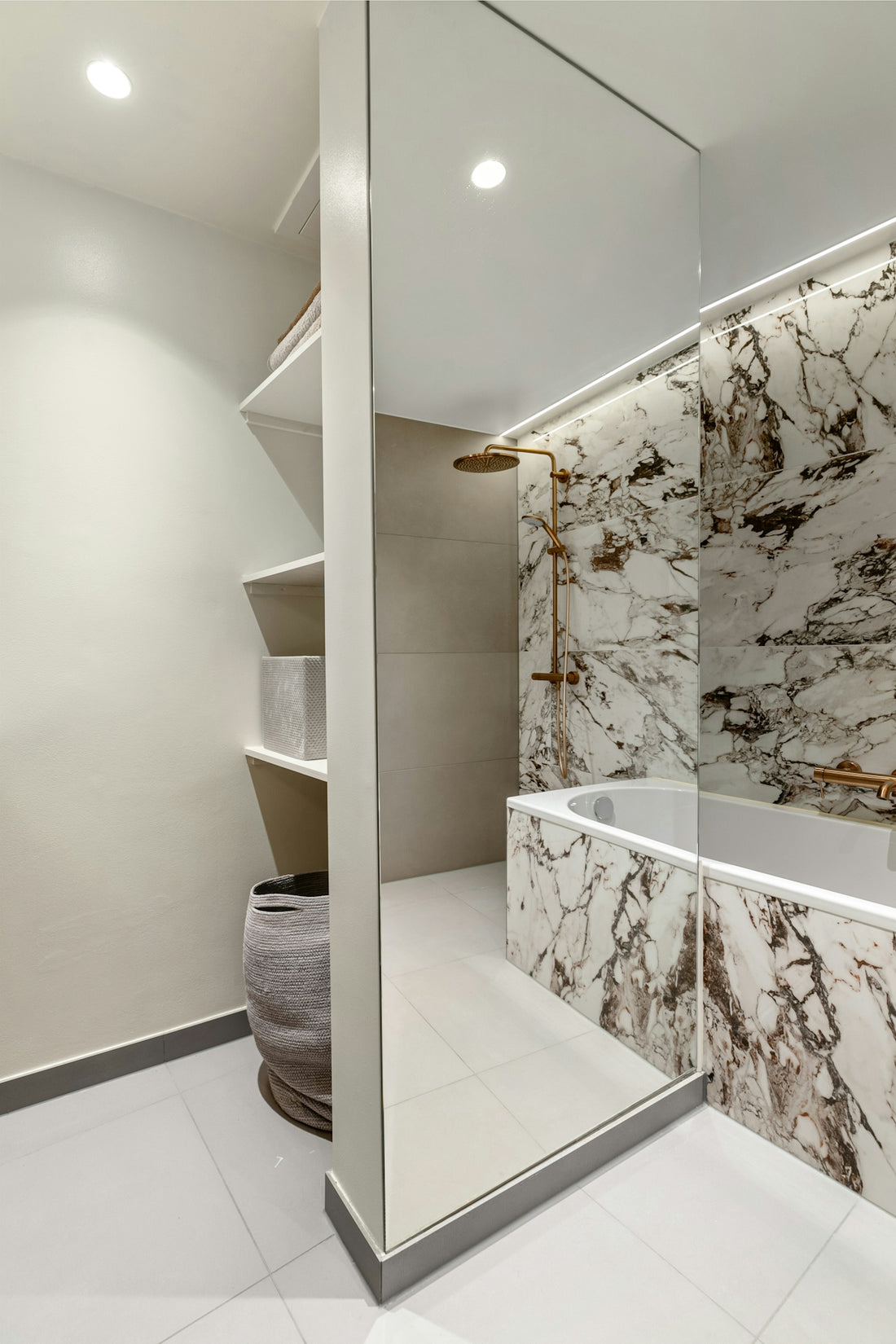 A bathroom with marble walls and a tub