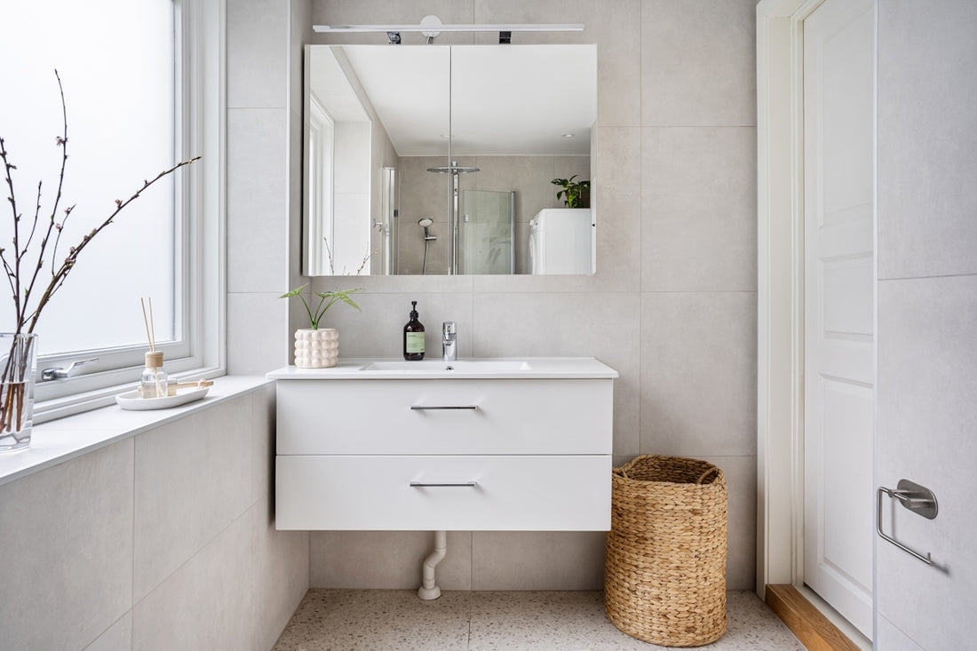A bathroom with a sink, mirror and window