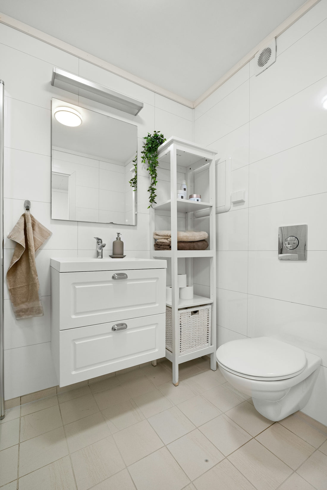 A white bathroom with a toilet and a sink