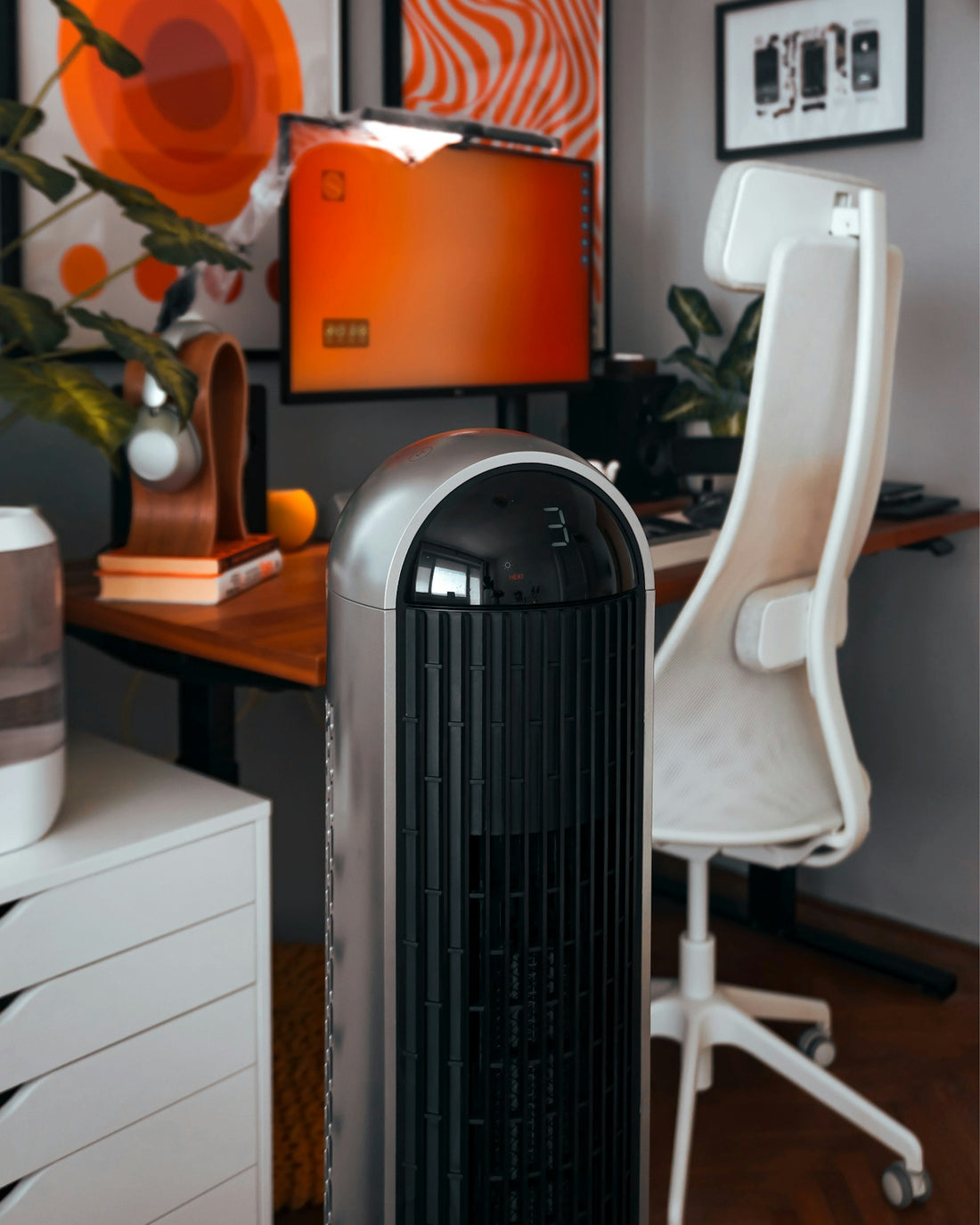 A room with a desk, chair, and air conditioner
