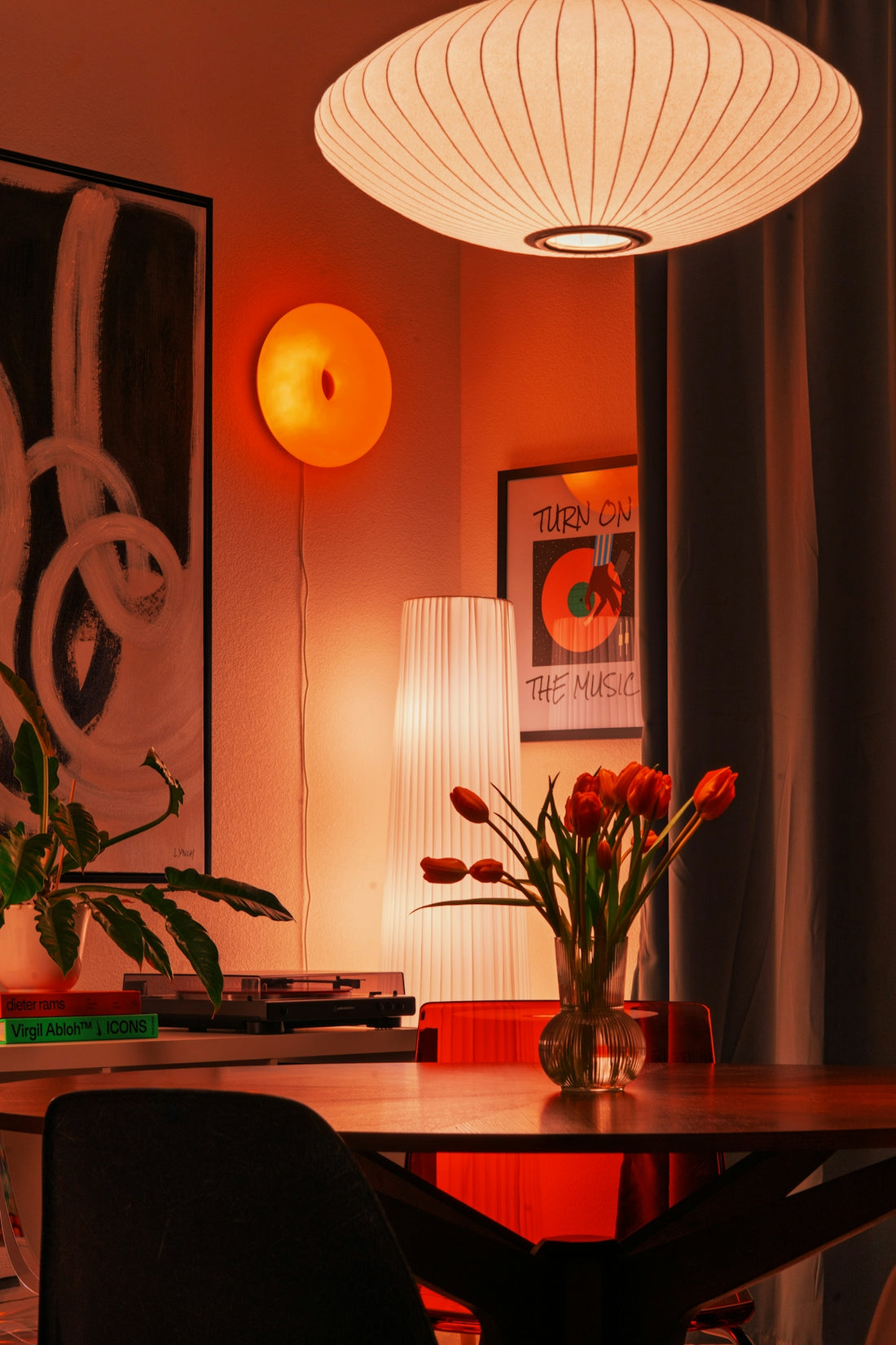A cozy room with warm lighting and flowers.