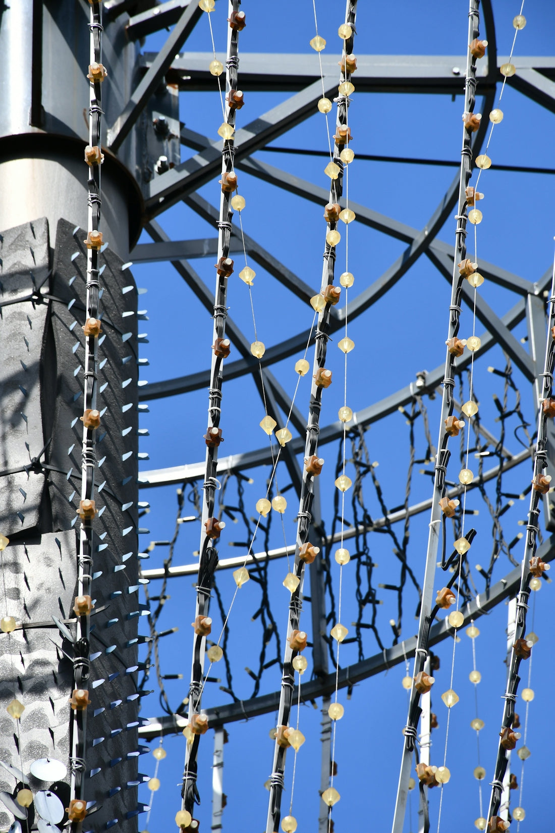 Decorative lights hang from a modern metal structure.