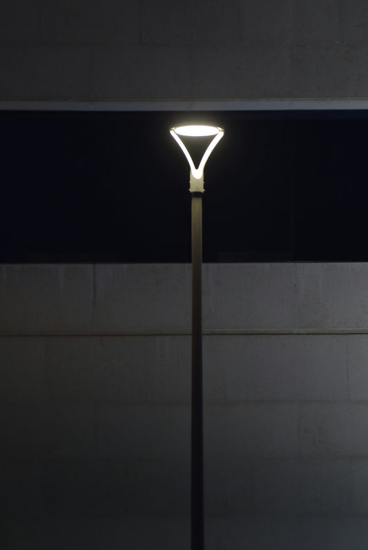Modern street lamp illuminated at night.
