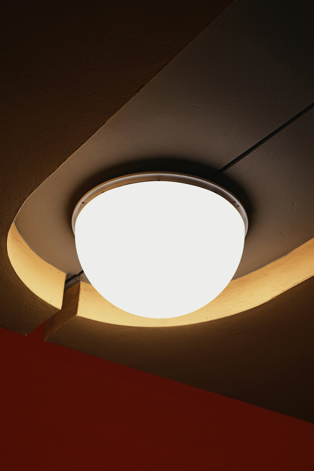 A modern ceiling light fixture with warm ambient lighting.