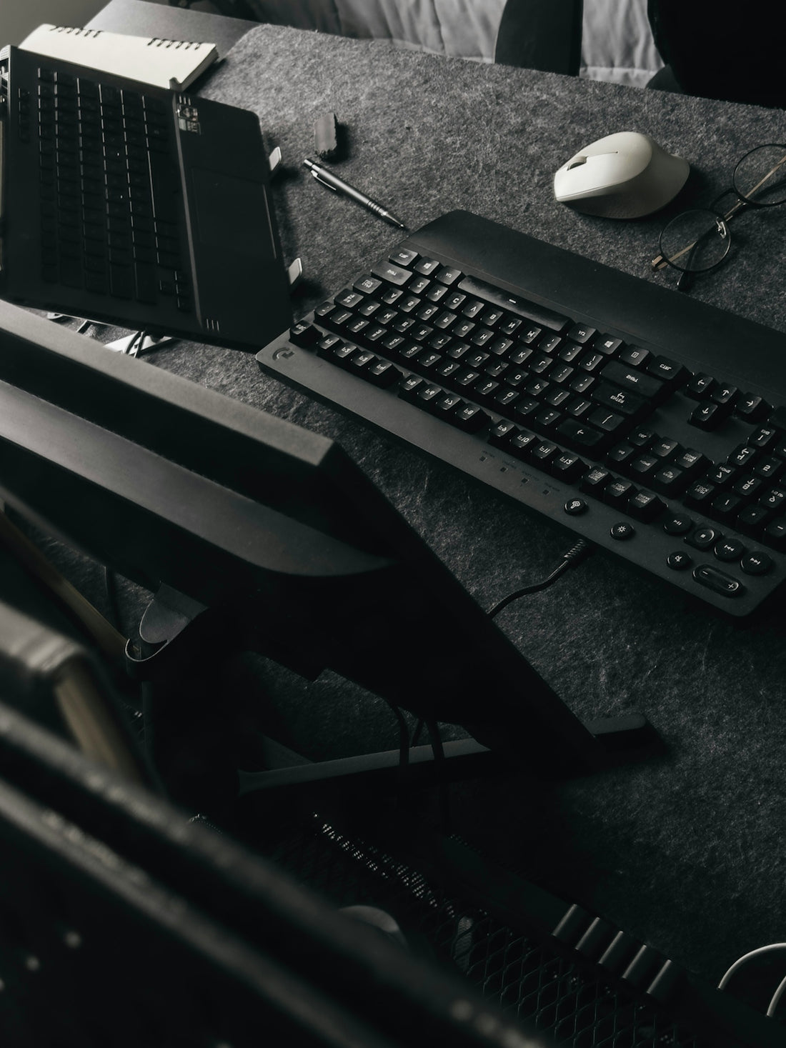 A black keyboard and mouse on a desk.