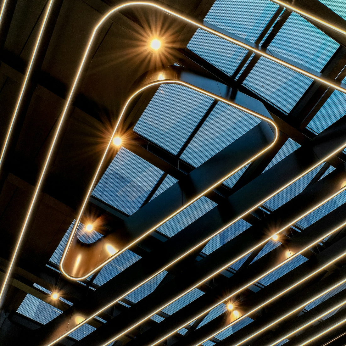 Modern ceiling with geometric lighting and skylights