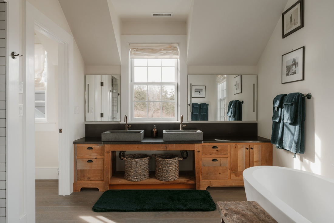 A modern bathroom with double sinks and a bathtub.