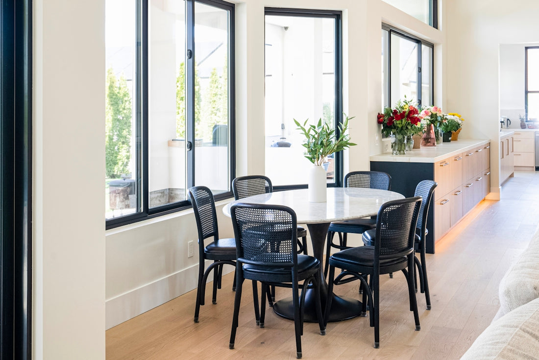 Modern dining room with oval table and chairs.