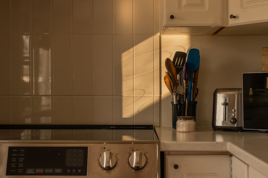 Kitchen counter with utensils and toaster at sunset