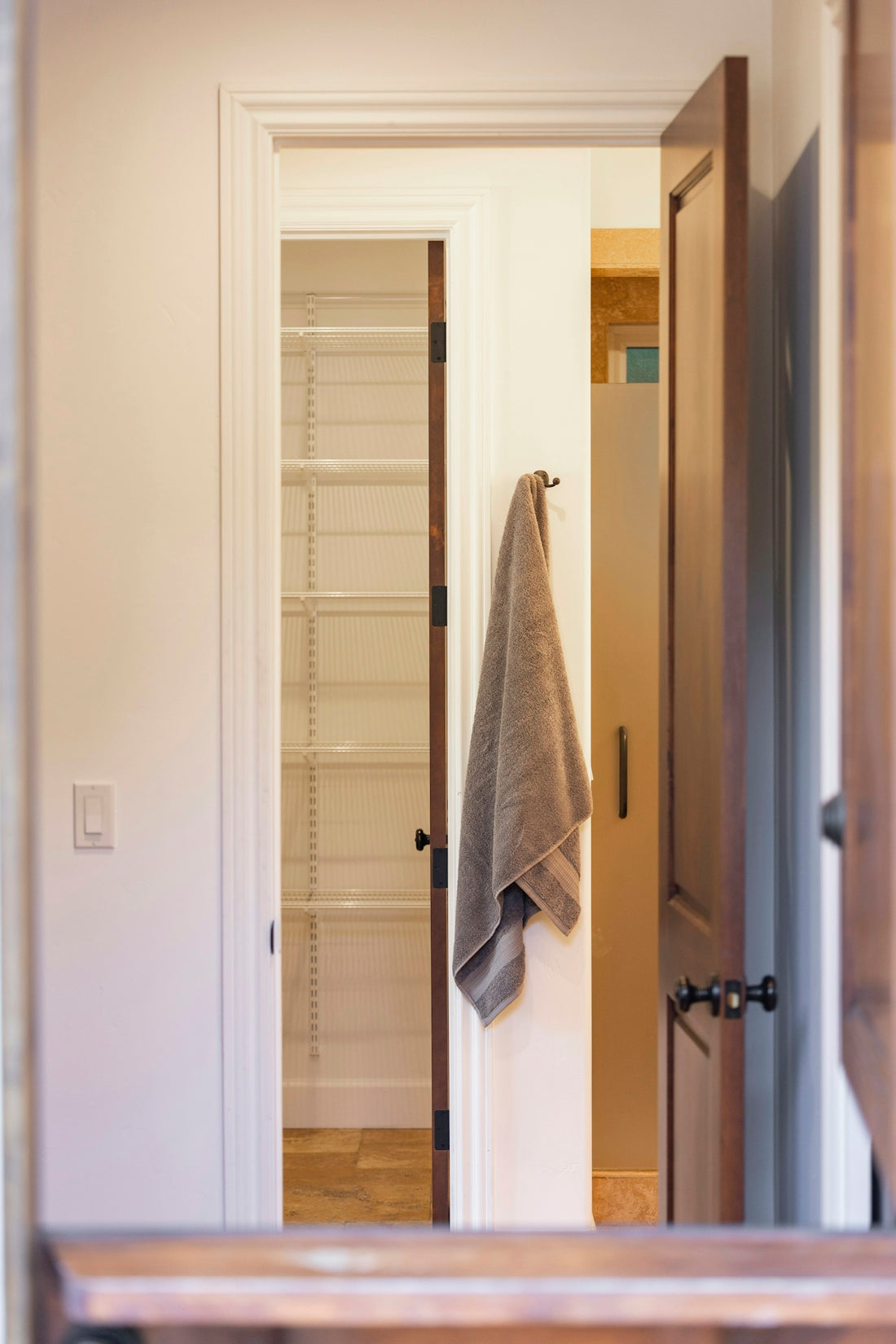 Interior view of a closet and bathroom with a towel.