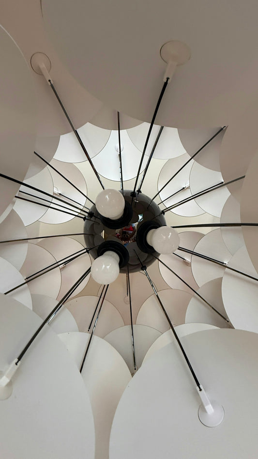 Modern chandelier with radiating white elements and bulbs